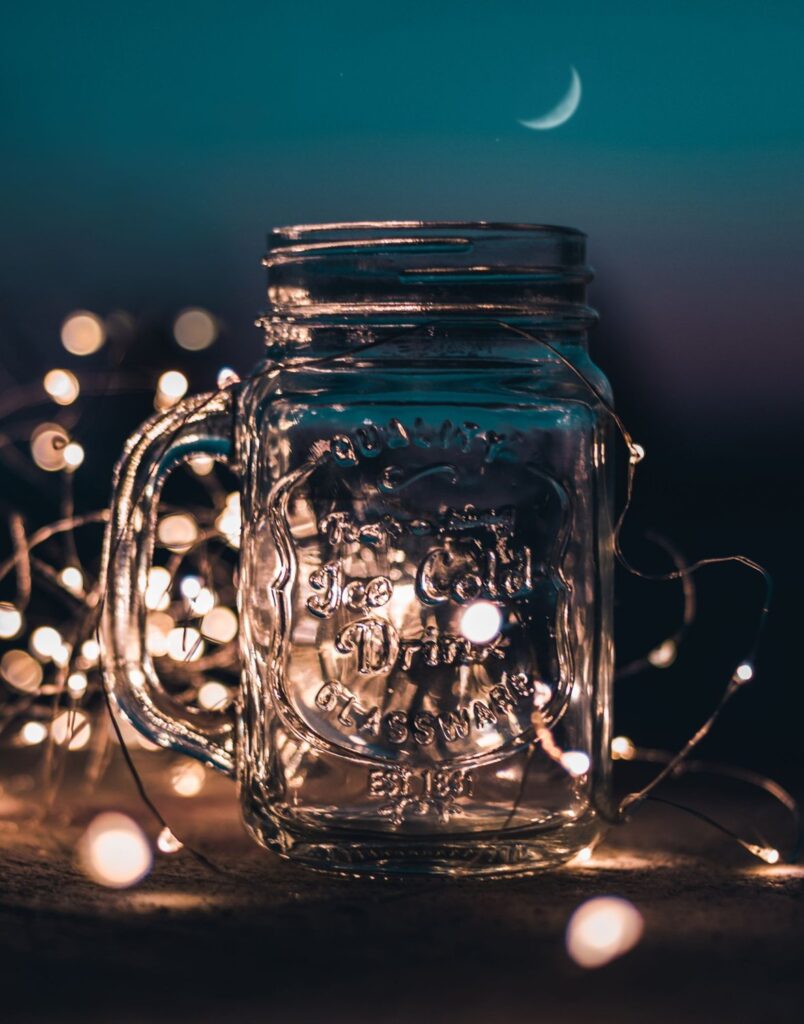 Clear mason jar filled with glowing fairy lights