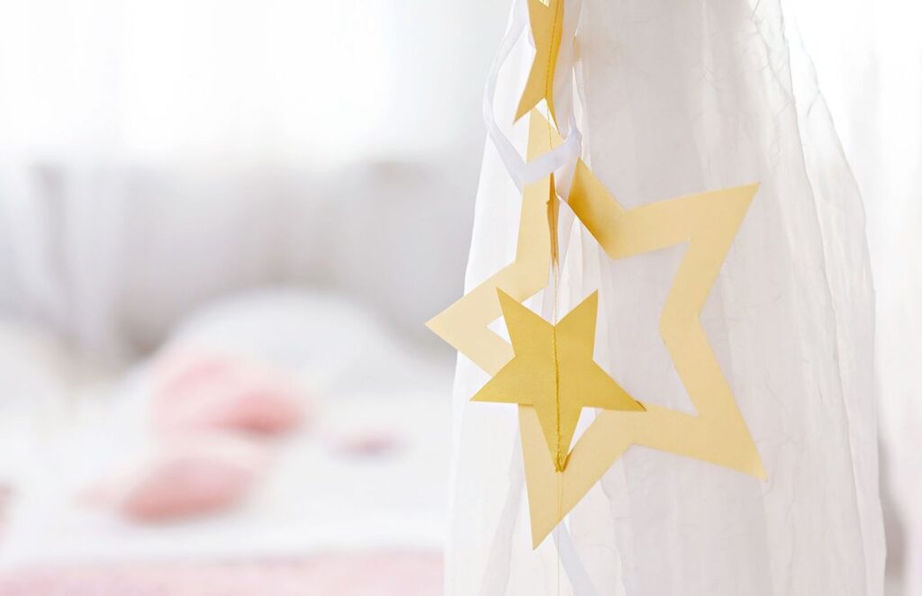 Folded paper star decorations hanging in a soft window light