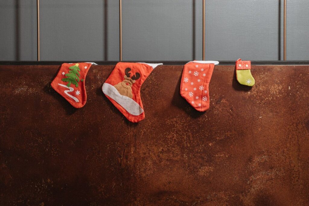 Four patterned Christmas stockings hanging on a wall