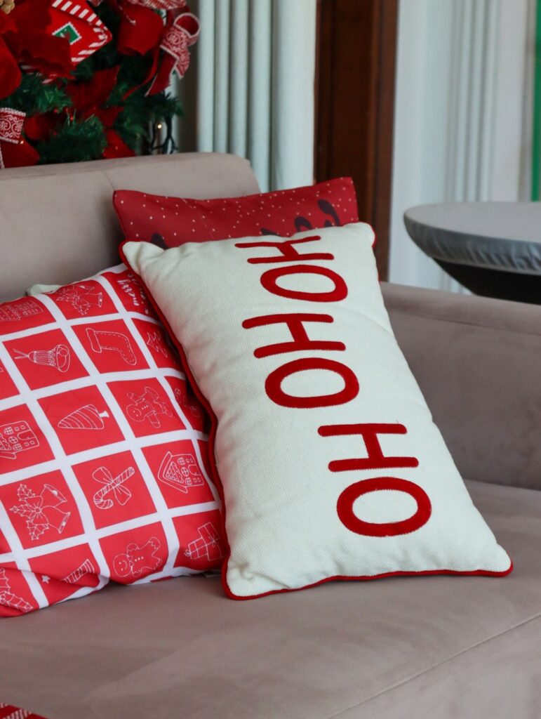 Sofa with red check and 'Ho Ho Ho' Christmas pillows