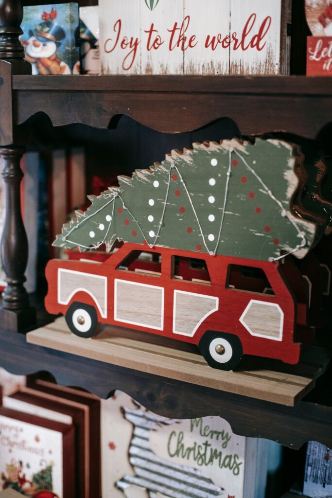 Shelf with a toy truck carrying a Christmas tree and holiday books